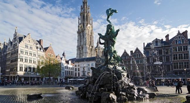 ANTWERP, BELGIUM - OCTOBER 26: The Grand Place with the Statue of Brabo, throwing the giant's hand into the Scheldt River and the Cathedral of our Lady.  on October 26, 2013 in  in Antwerp, Belgium. 