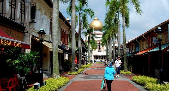 SINGAPORE - December 18, 2007:  Bussorah Street lined with old shop houses offers a fine view of the 1924-28 Masjid Sultan Singapura Mosque in the Kampong Glam historic Arab quarter; 