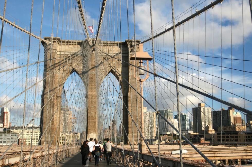 Tourists and residents of New York on Brooklyn Bridge