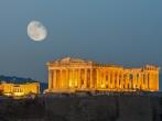 Parthenon construction in Acropolis Hill in Athens, Greece shot in blue hour with moon in the sky