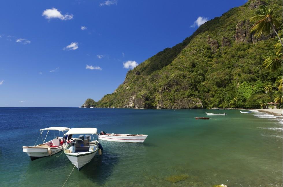 Boats on the clear waters of a beach in Soufriere in St Lucia;  
