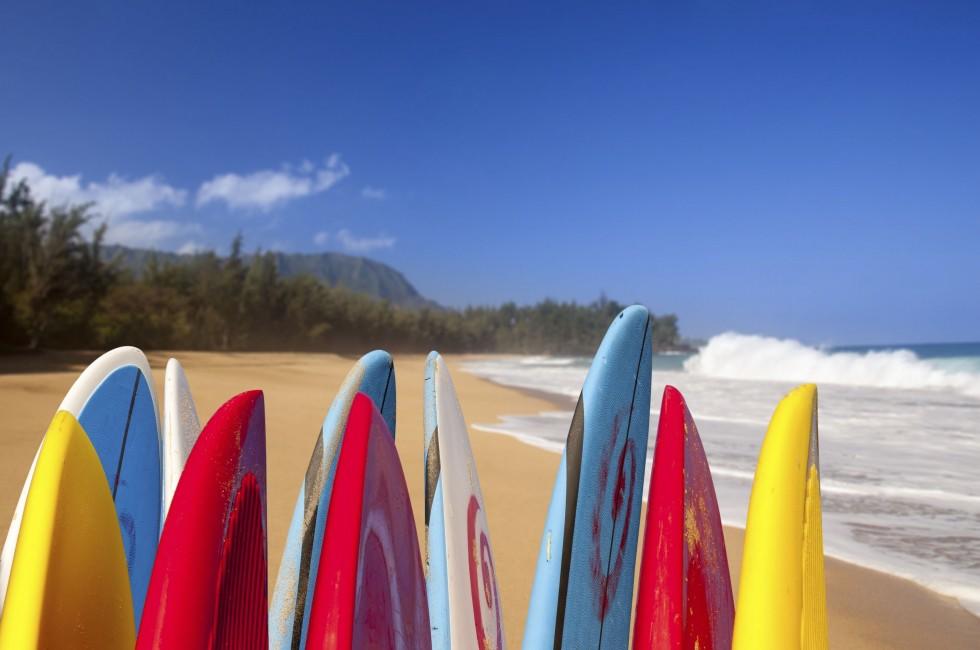 Tips of surfboards at Lumahai beach in Kauai Hawaii on a sandy shore by the ocean.