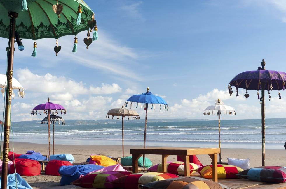 Colorful beach umbrellas and pillows in Kuta, Bali.