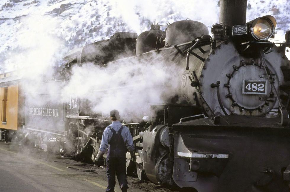 Train, Durango, Colorado; conductorl person; snow; moutain; smoke