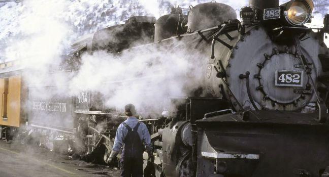 Train, Durango, Colorado; conductorl person; snow; moutain; smoke