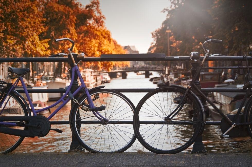 Two bikes on a bridge over a canal in Jordaan, Amsterdam, Netherlands