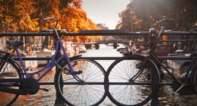 Two bikes on a bridge over a canal in Jordaan, Amsterdam, Netherlands