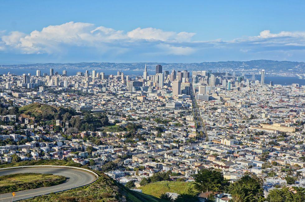 View of the city of San Francisco from Twin Peaks on a sunny day with clouds.