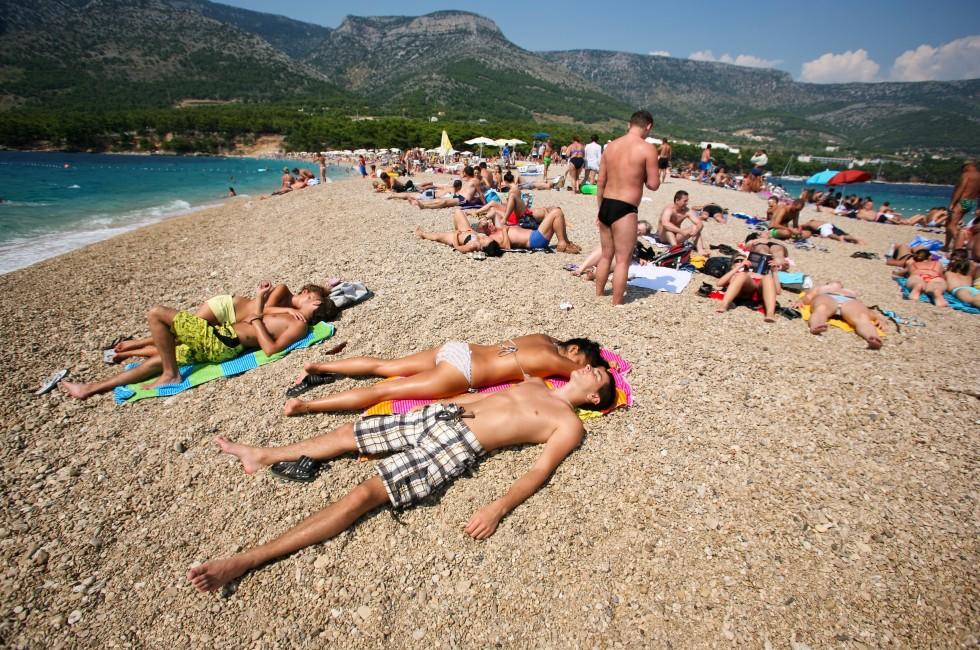 ZAGREB - JULY 29: Crowded beach of Zlatni Rat on June 05, 2009 in Bol, Croatia. Bol is one of the busiest tourist destinations on the adriatic islands.