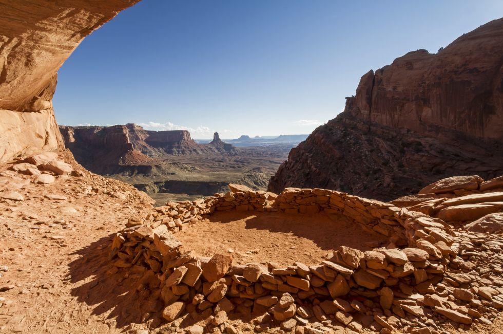 So-called 'False Kiva' class 2 archaeological site in Canyonlands National Park, with a view of Candlestick Tower in the Background. Utah