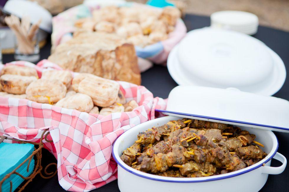 Fresh roasted bread and mutton kebabs in dishes on a table