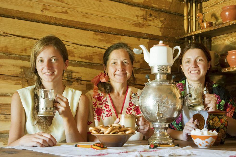 three women having tea in russian traditional interior; Shutterstock ID 65049394; Project/Title: Moscow ebook