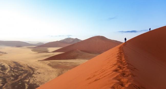 People walking on beautiful sunrise dunes of Namib desert, Sossusvlei, Namibia, South Africa