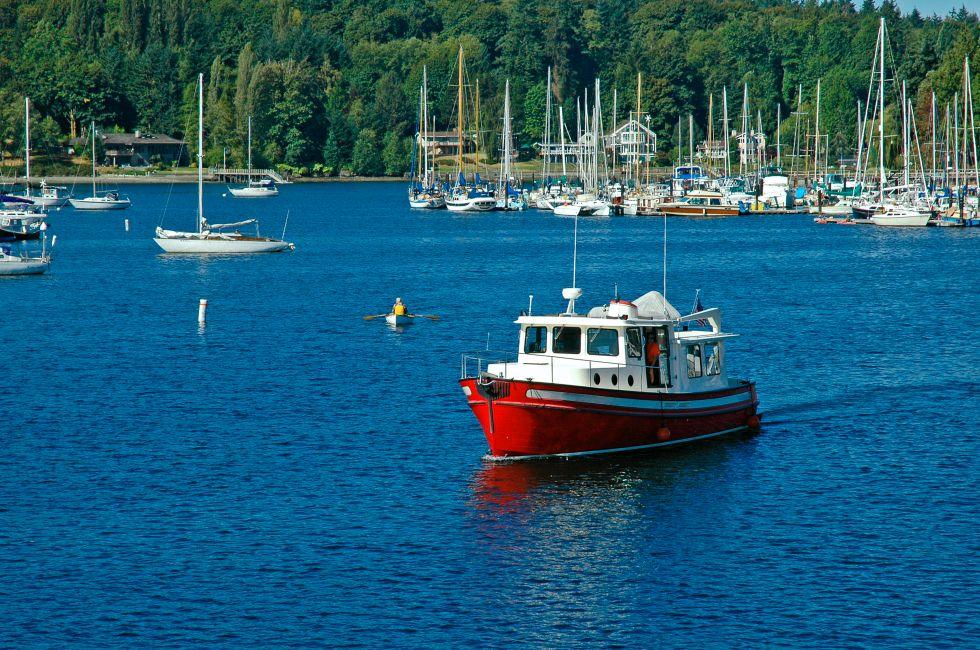 Red boat cruising through the harbor at Bainbridge Island, WA. 