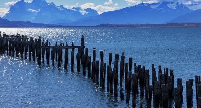 Patagonia bay and mountains from Puerto Natales with cormorants on old pilings and Mount Balmaceda across Last Hope Sound; Shutterstock ID 166388384; Project/Title: Chile; Downloader: Fodor's Travel
