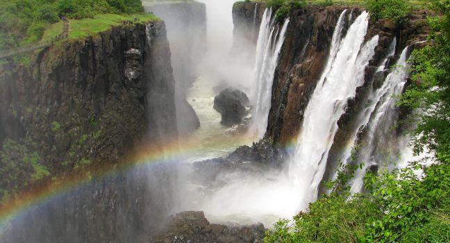 Rainbow over Victoria Falls on Zambezi River, border of Zambia and Zimbabwe; 