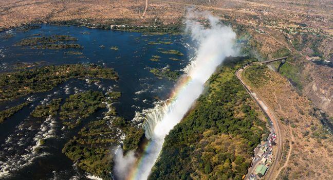 Victoria Falls (or Mosi-oa-Tunya - the Smoke that Thunders) waterfall in southern Africa on the Zambezi River at the border of Zambia and Zimbabwe. Aerial Image taken from helicopter flight