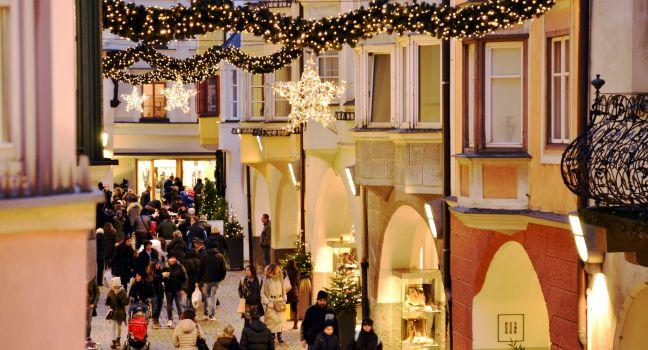 BRESSANONE BRIXEN, ITALY: DECEMBER 8, 2014: Traditional Christmas time, with scenic winter view and tourists of the Old Town in Bressanone Brixen on December 8, 2014