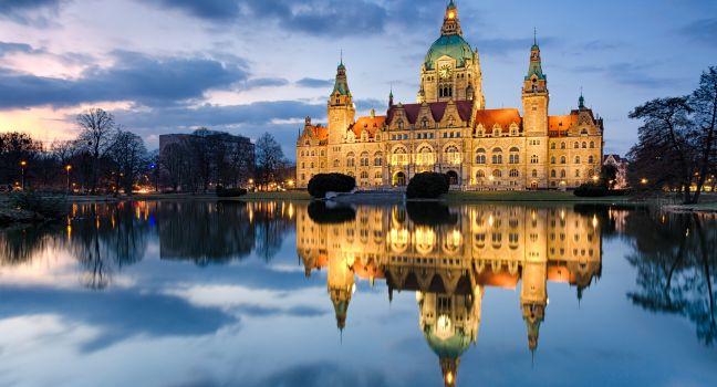 City Hall of Hannover, Germany by night with cloudy sky and reflection in a lake. Photo taken on: April 06th, 2013 