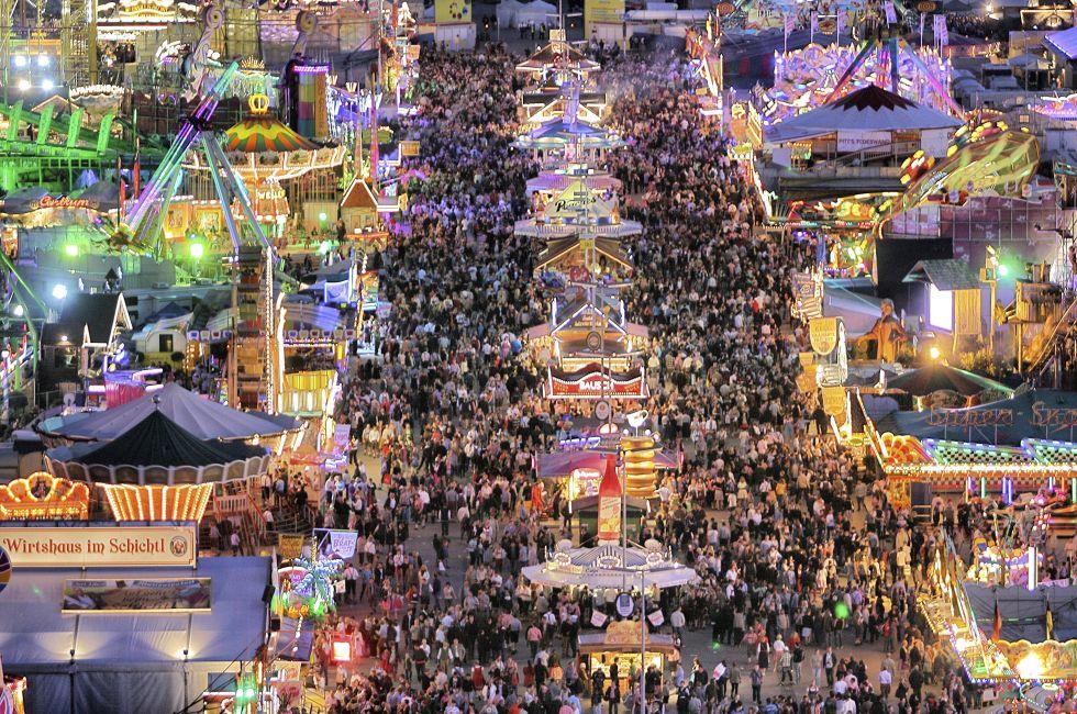 MUNICH - SEPTEMBER 28: Large numbers of tourists and locals come to see the attractions of the world's famous fun fair and beer festival Oktoberfest in Munich, Germany at night on September 28, 2012.; Shutterstock ID 114852403; Project/Title: 15 Places to 