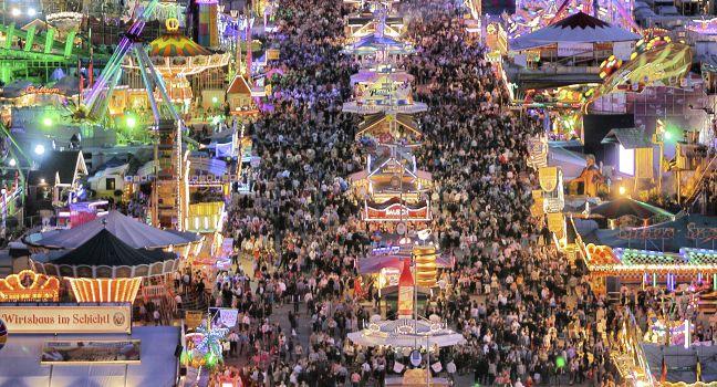 MUNICH - SEPTEMBER 28: Large numbers of tourists and locals come to see the attractions of the world's famous fun fair and beer festival Oktoberfest in Munich, Germany at night on September 28, 2012.; Shutterstock ID 114852403; Project/Title: 15 Places to 