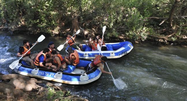 DAN RIVER, ISR - MAY 20:Young Israeli people river rafting on Dan River on May 20 2009.It's the largest of the three principal tributaries of the Jordan River.; Shutterstock ID 141593782; Project/Title: Fodors Israel; Downloader: Melanie Marin