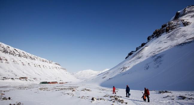 A group of people walking along a path ouside Longyearbyen, Spitsbergen, Svalbard, Norway