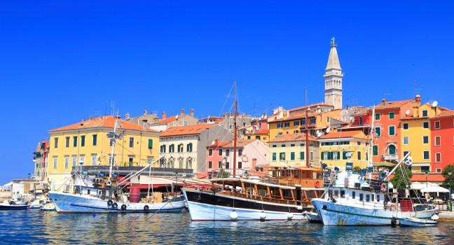 Tourist and fishing vessels in the harbor of Venetian town near the Adriatic sea, Rovinj, Croatia