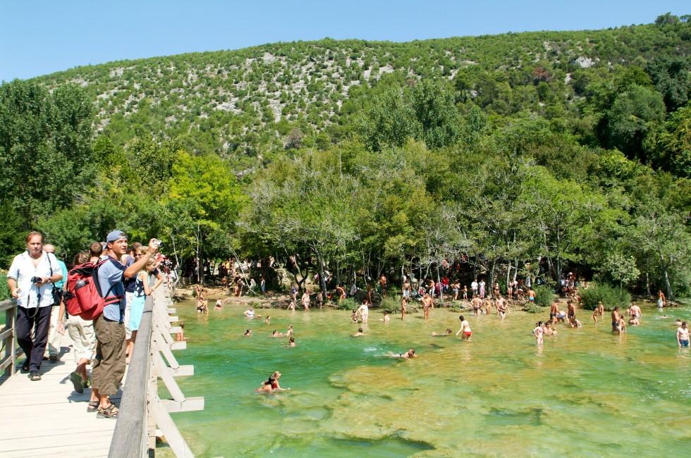 Krka, Croatia - 26 August 2004: tourists walking and swimming at the Krka national park on Croatia