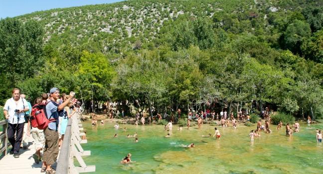 Krka, Croatia - 26 August 2004: tourists walking and swimming at the Krka national park on Croatia
