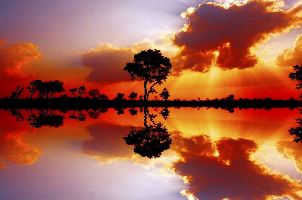 Beautiful African sunset reflected in water, in the Kruger National Park, South Africa; 