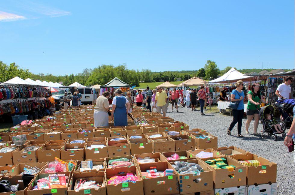 Shoppers wandering the pathways, rummaging through vendors interesting sale items at The Green Dragon farmers market,Ephrata,Pennsylvania,May,2013.