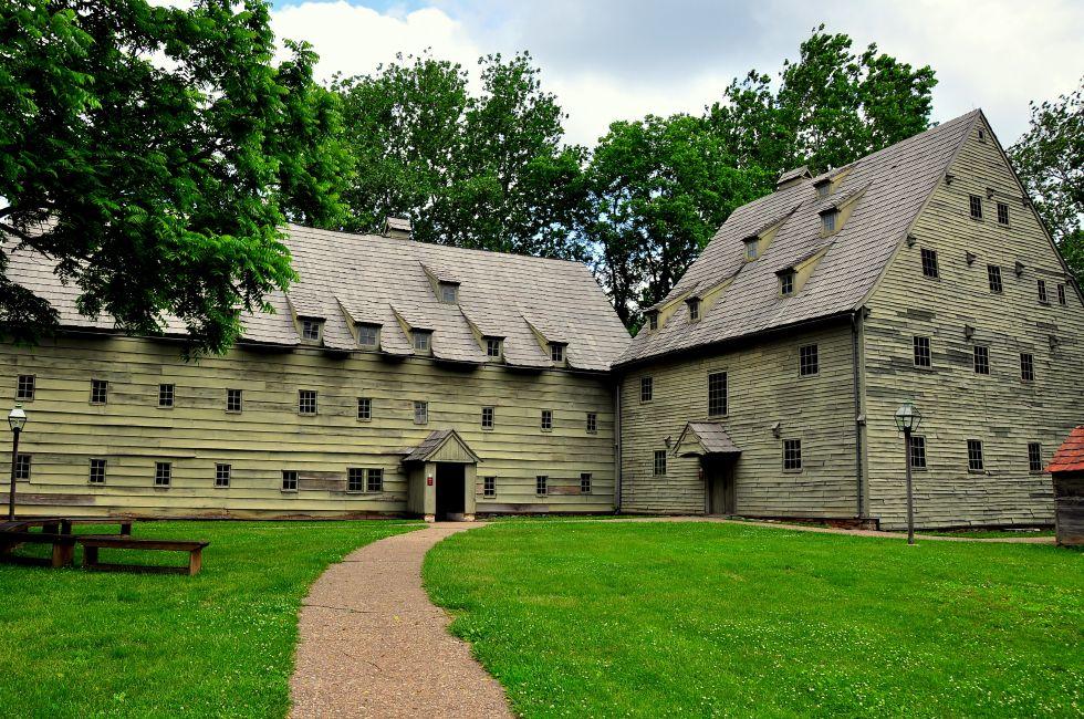 Ephrata, Pennsylvania: The wooden 1743 Saron (Sisters' House) on left and 1741 fachwerk Saal (Meeting House) at the Ephrata Cloister historic Germanic religious settlement. Photo taken on: June 06th, 2015 