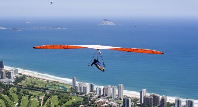 Hand glider flying over the beautidul scenery of Rio de Janeiro's coast.