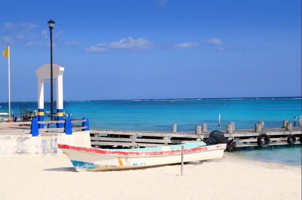 Puerto Morelos beach with boat in turquoise Caribbean; 