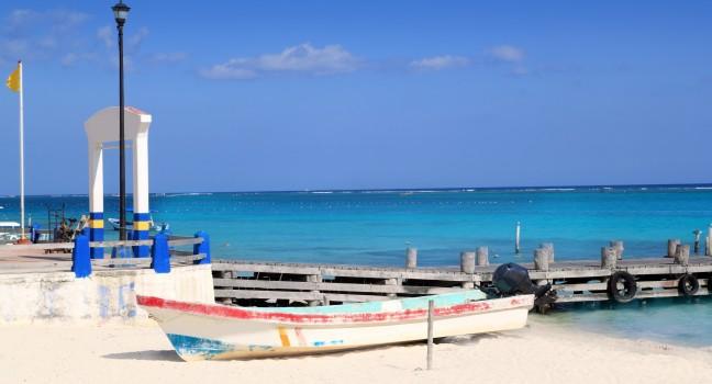 Puerto Morelos beach with boat in turquoise Caribbean; 