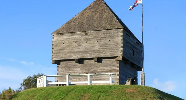 Fort Howe, the site of an 18th and 19th century British Army fortification on a hill in Saint John, New Brunswick, Canada surrounded by blue sky with waving flag; 