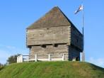 Fort Howe, the site of an 18th and 19th century British Army fortification on a hill in Saint John, New Brunswick, Canada surrounded by blue sky with waving flag; 