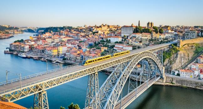 View of the historic city of Porto, Portugal with the Dom Luiz bridge. A metro train can be seen on the bridge; Shutterstock ID 148234274; Project/Title: Fodors Portugal Gold Guide; Destination: Portugal; Downloader: Jessica Parkhill