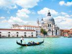 Traditional Gondola on Canal Grande with Basilica di Santa Maria della Salute in the background, Venice, Italy.