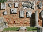 Wall with old reliefs in island of Torcello, Italy.
