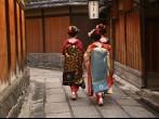 Three geishas walking on a street of Gion (Kyoto, Japan).