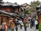 KYOTO, JAPAN - APRIL 10 2012: Tourists wander a famous street, Sannen-Zaka, in Kyoto on April 10 2012.  The street is located in the heart of Kyoto attractions. Many souvenir shops can be found here.