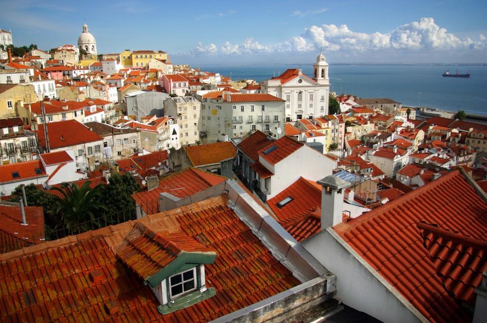 Panorama of old traditional city of Lisbon with red roofs and view of river Tagus 