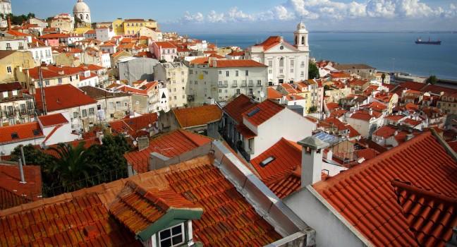 Panorama of old traditional city of Lisbon with red roofs and view of river Tagus 