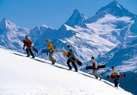 Snowboarders with view of matterhorn